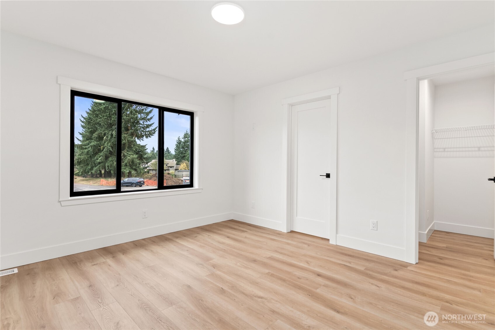 15809 239th Street East Graham, WA 98338 - Photo 19 of 40 a view of an empty room with wooden floor and a window
