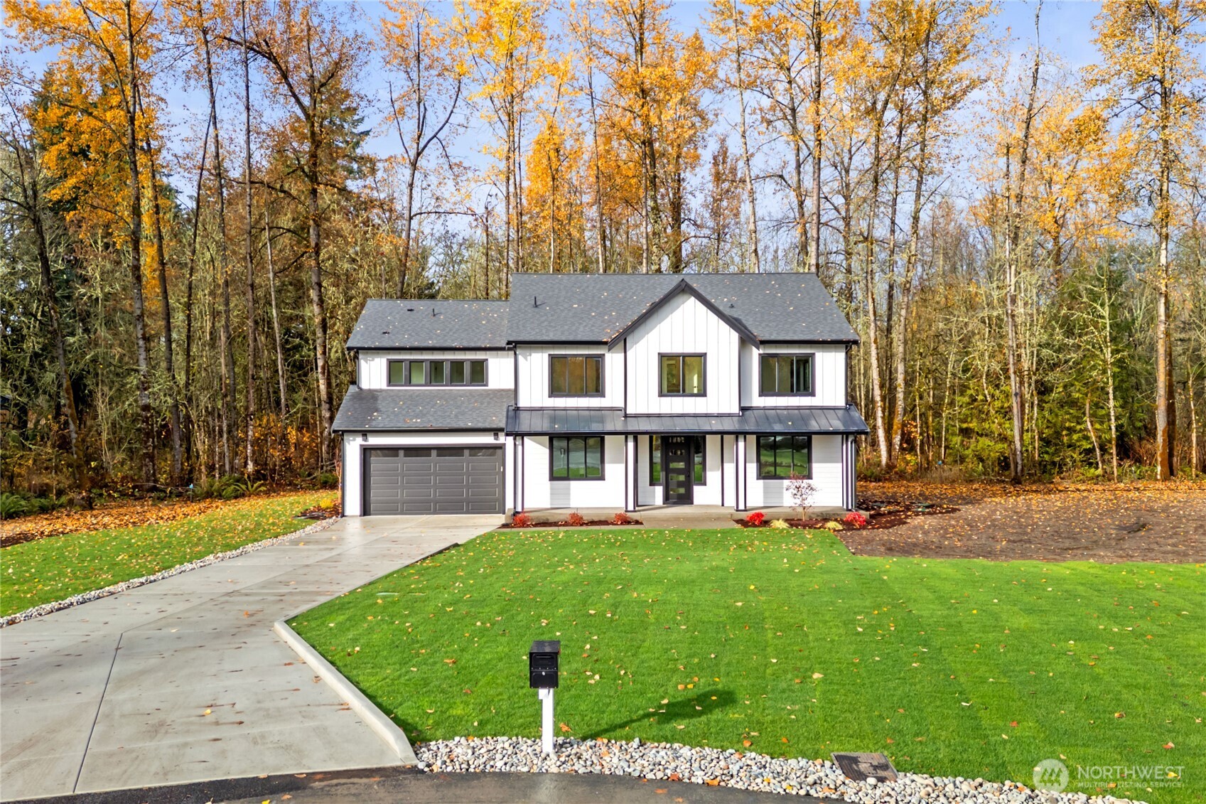 15809 239th Street East Graham, WA 98338 - Photo 2 of 40 a front view of a house with a yard and trees