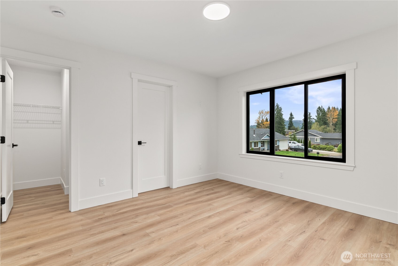 15809 239th Street East Graham, WA 98338 - Photo 23 of 40 a view of an empty room with wooden floor and a window