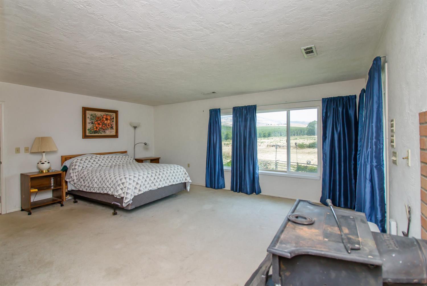 1039 West Valley View Road Ashland, OR 97520 - Photo 15 of 32 a bedroom with a bed and window