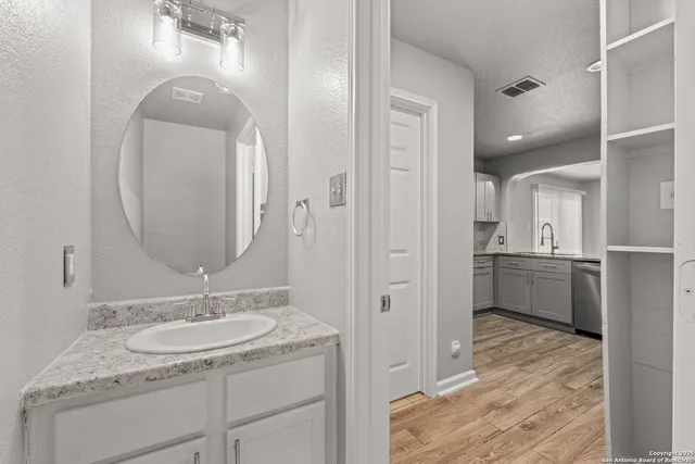 a en suite bathroom with a sink double vanity and a mirror