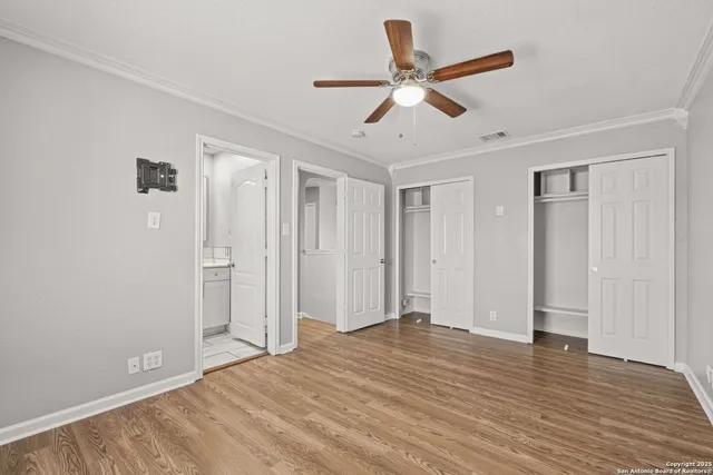a view of a livingroom with a ceiling fan and wooden floor