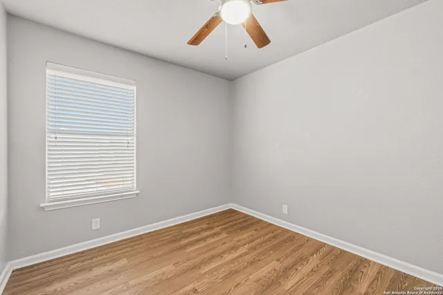 a view of a room with a wooden floor and a window