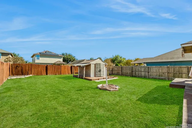 a view of a house with a yard table and chairs