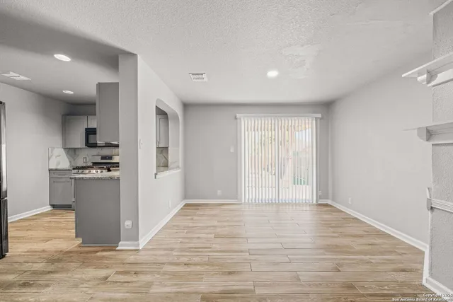a view of kitchen with refrigerator and microwave