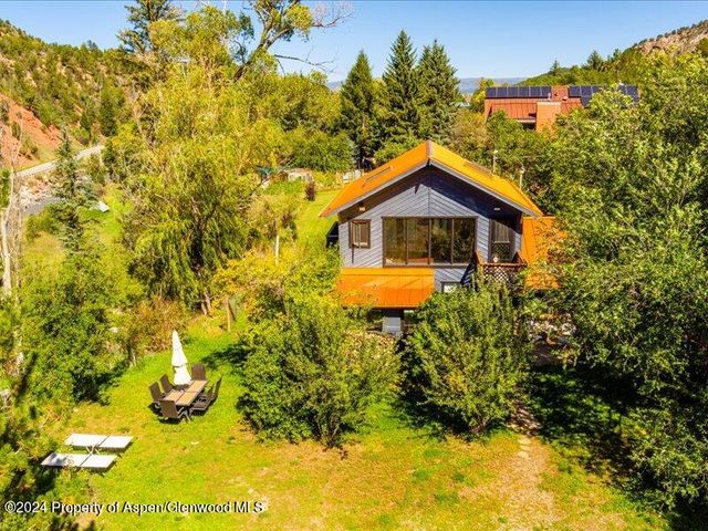 a view of a house with yard and sitting area
