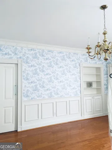 a view of a livingroom with wooden floor and a fireplace