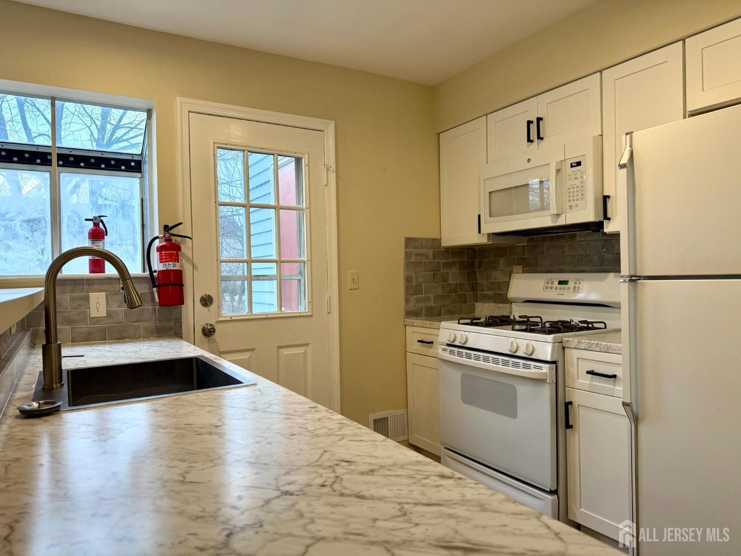 384 Inwood Court Somerset, NJ 08873 - Photo 12 of 29 a utility room with stainless steel appliances a stove a refrigerator and cabinets