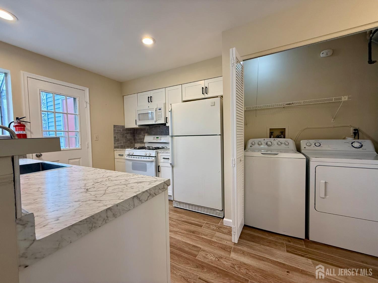 384 Inwood Court Somerset, NJ 08873 - Photo 13 of 29 a kitchen with a refrigerator and a stove top oven