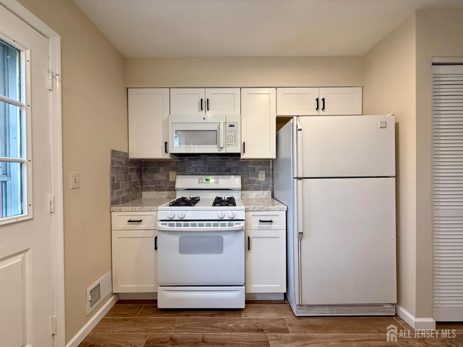 384 Inwood Court Somerset, NJ 08873 - Photo 14 of 29 a white refrigerator freezer and a stove sitting inside of a kitchen