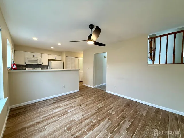 a view of a kitchen with furniture and wooden floor