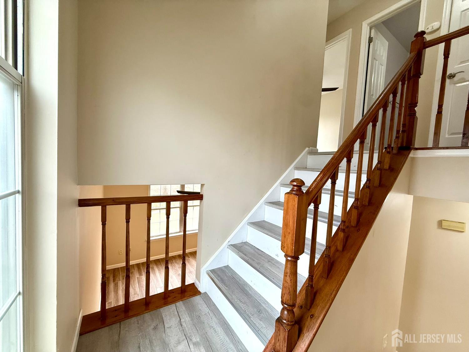 384 Inwood Court Somerset, NJ 08873 - Photo 18 of 29 a view of staircase with wooden floor and white walls