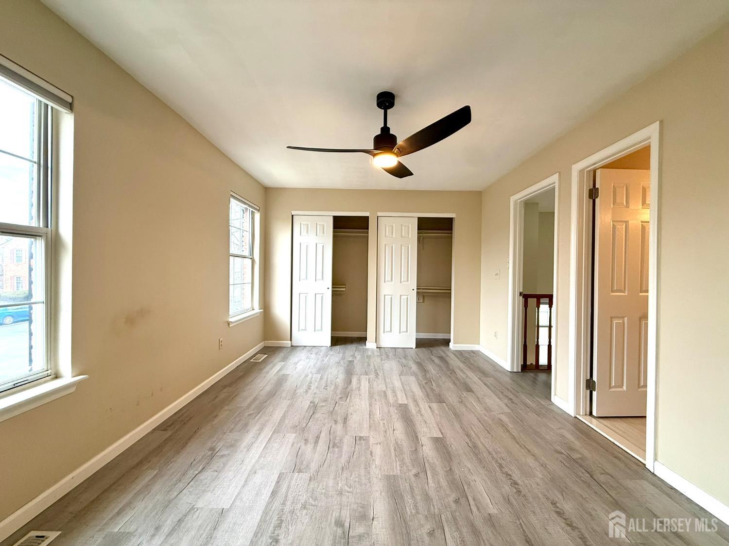 384 Inwood Court Somerset, NJ 08873 - Photo 22 of 29 a view of empty room with wooden floor and fan