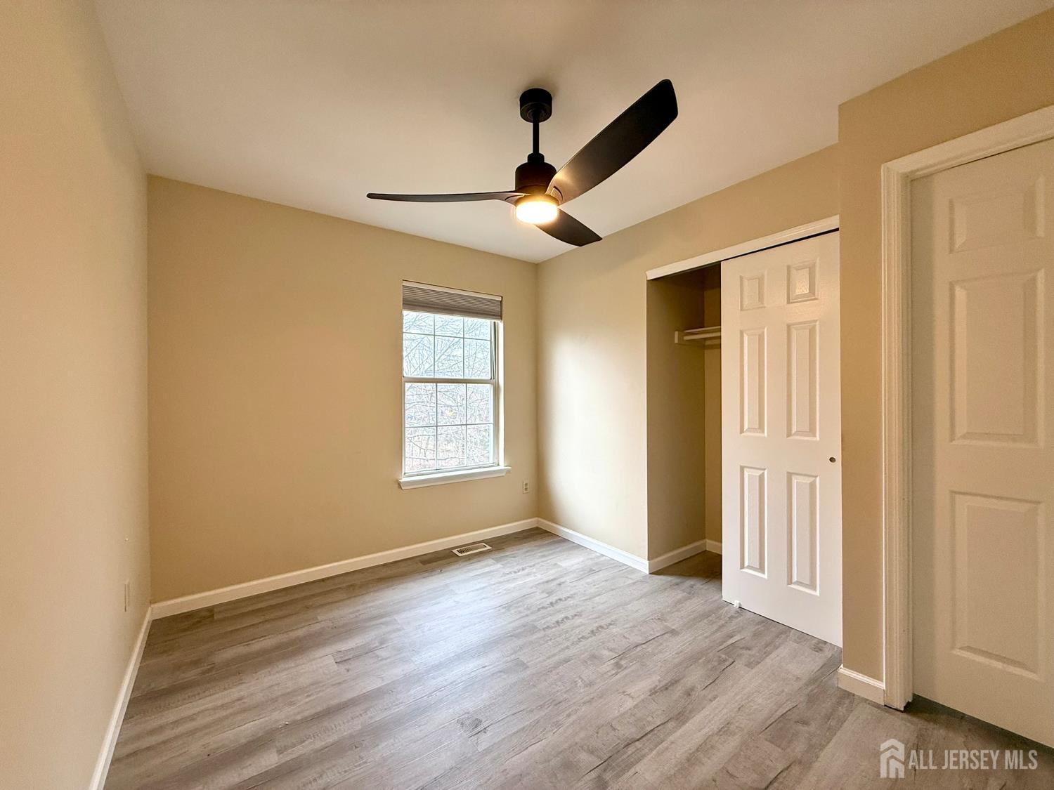 384 Inwood Court Somerset, NJ 08873 - Photo 27 of 29 a view of empty room with wooden floor and fan