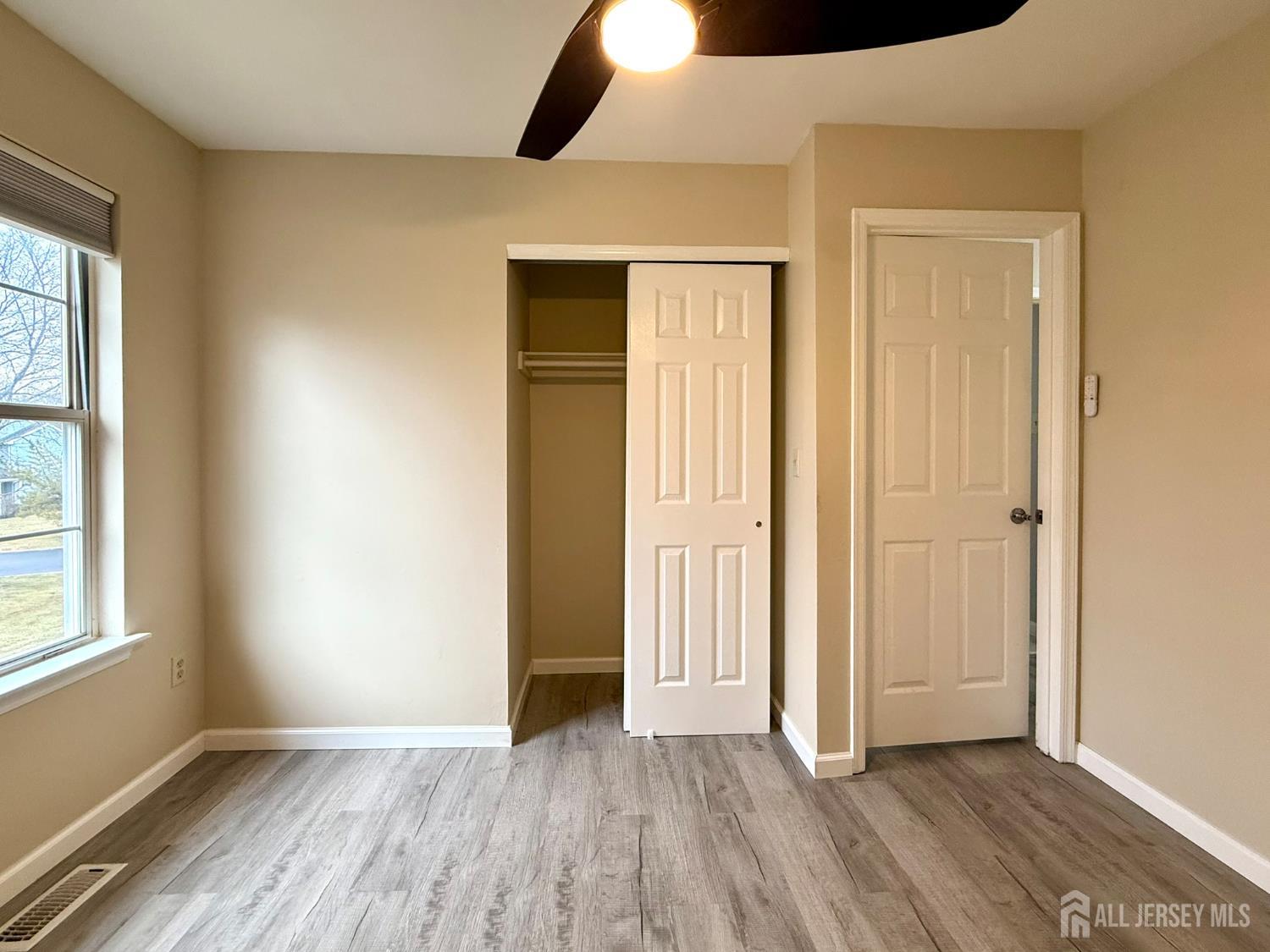 384 Inwood Court Somerset, NJ 08873 - Photo 28 of 29 an empty room with wooden floor and windows