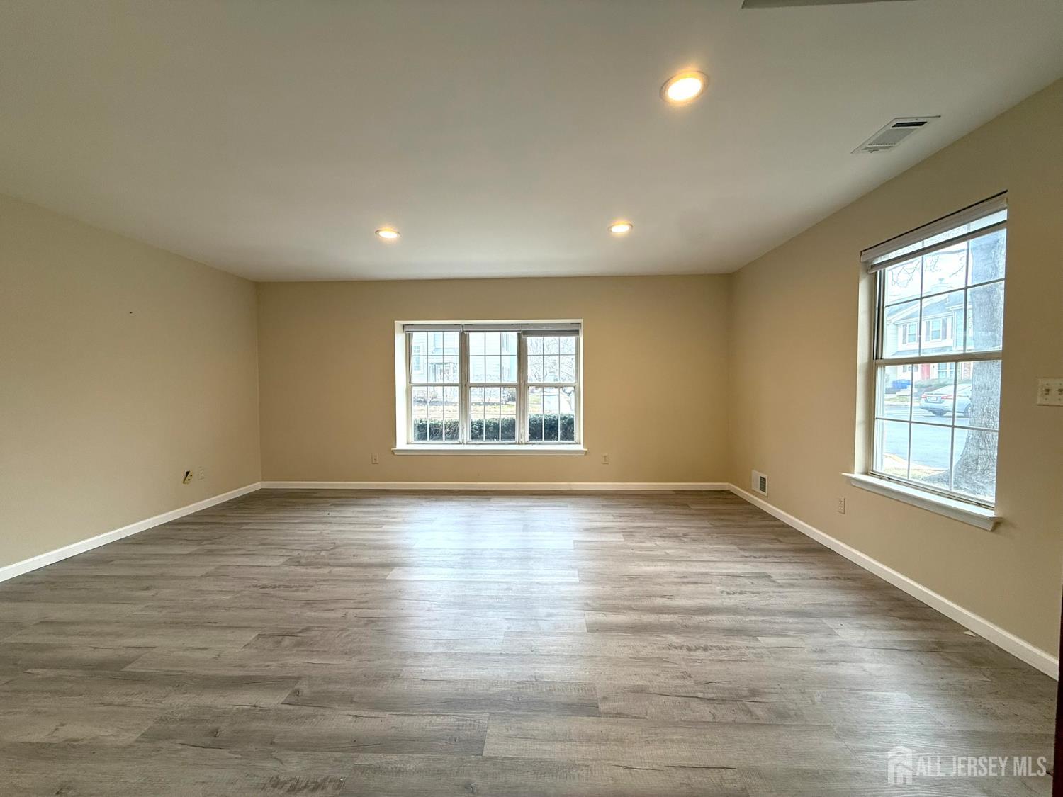 384 Inwood Court Somerset, NJ 08873 - Photo 7 of 29 an empty room with wooden floor and windows