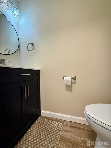 a bathroom with a granite countertop toilet and sink