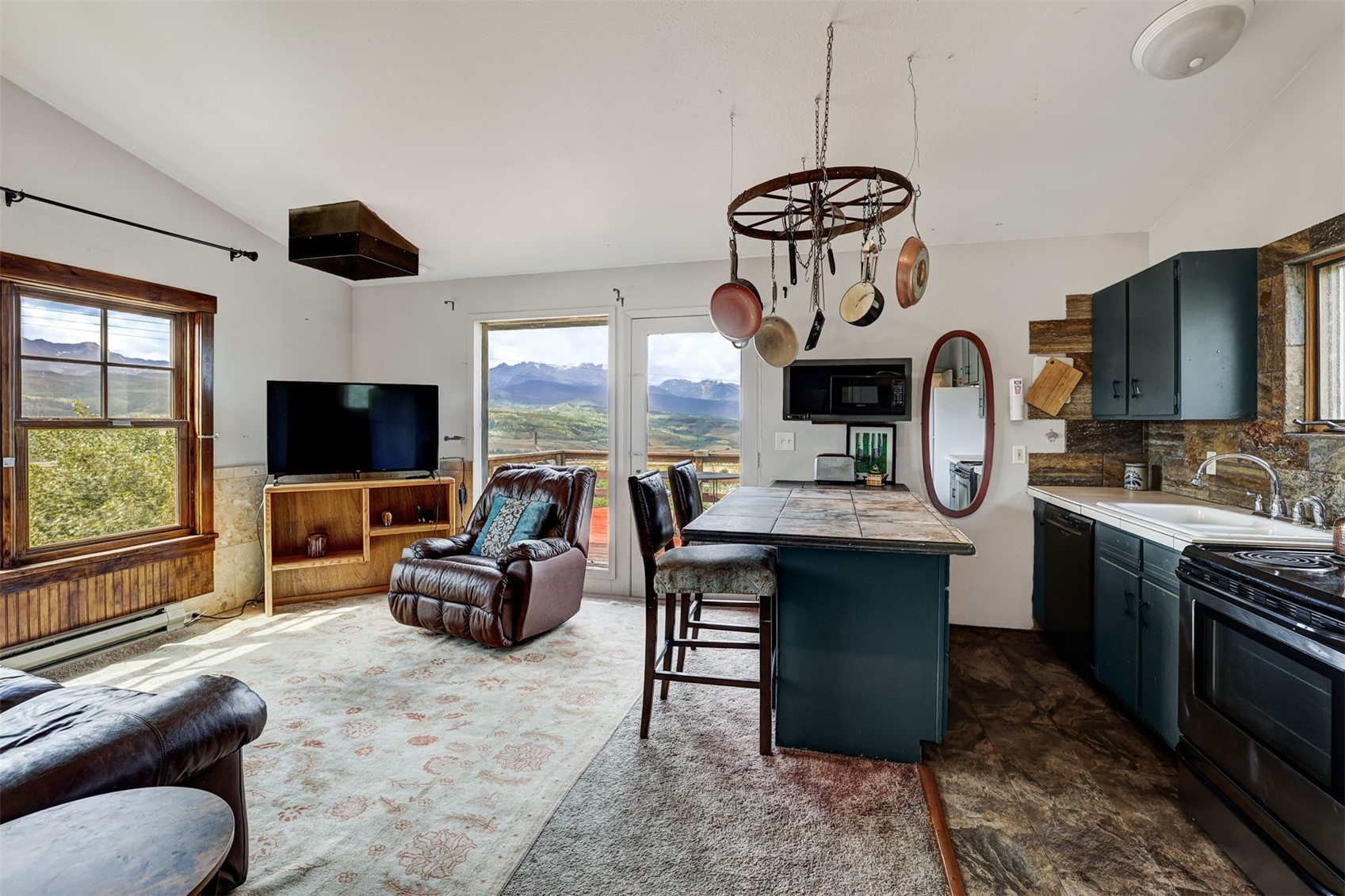 1703 Elk Run Road Silverthorne, CO 80498 - Photo 34 of 46 a living room with furniture a flat screen tv and kitchen view