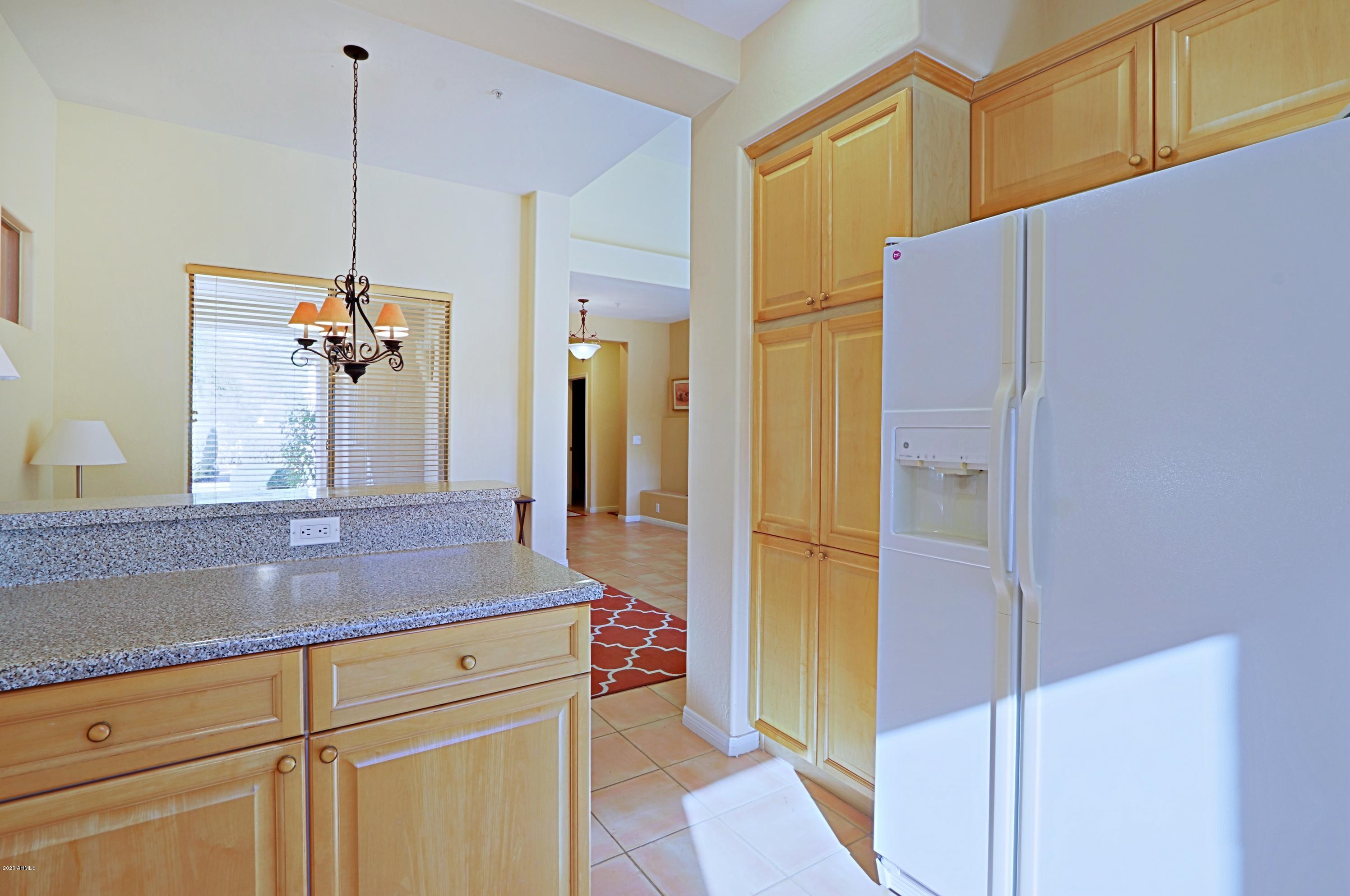 6803 East Eagle Feather Road Scottsdale, AZ 85266 - Photo 12 of 67 a kitchen with a refrigerator and countertop