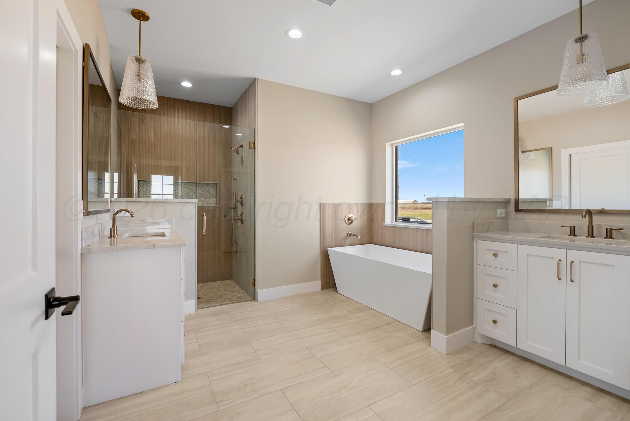 4201 Juniper Springs Road Amarillo, TX 79119 - Photo 17 of 27 a bathroom with a bathtub sink and mirror