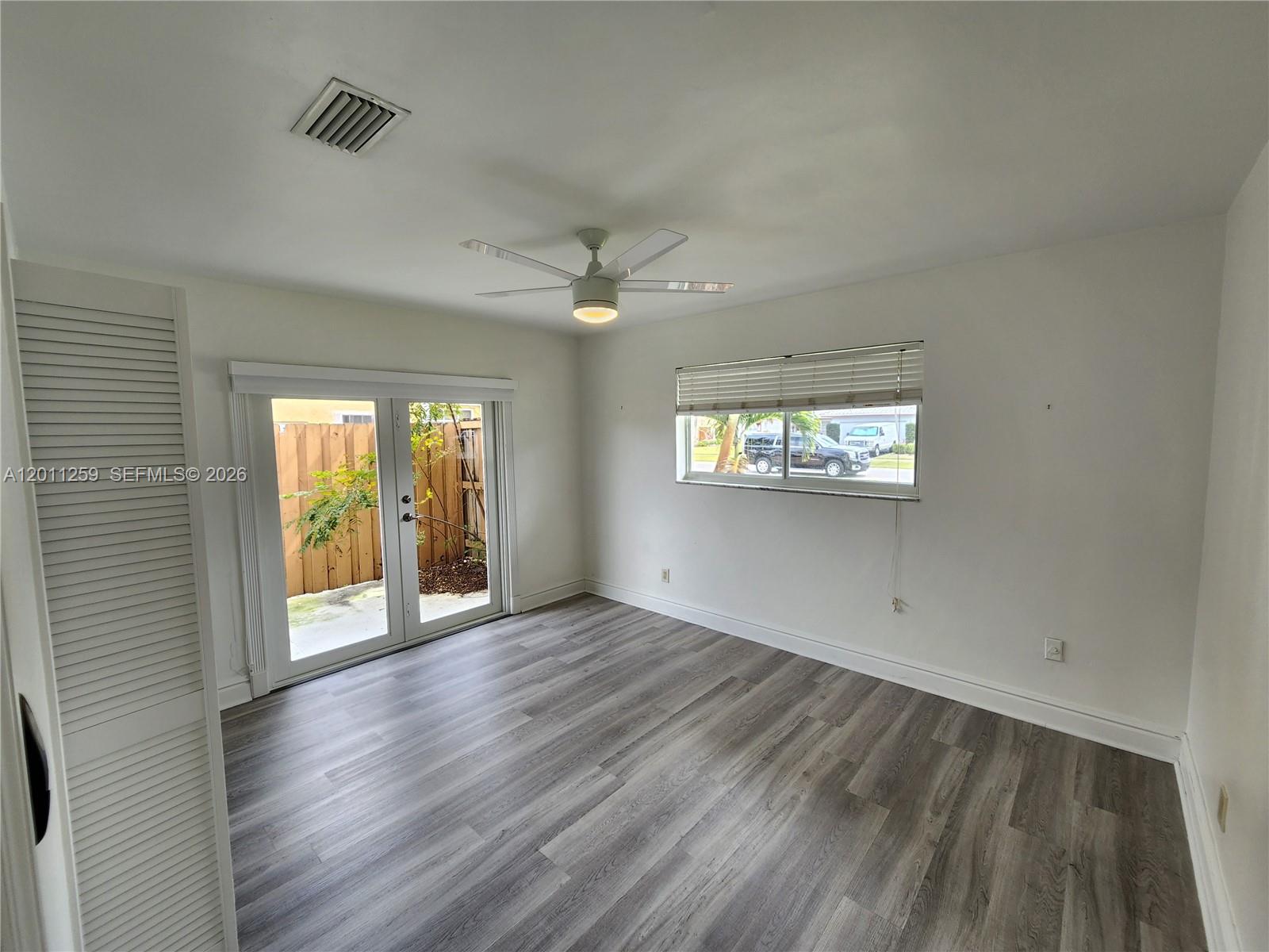 4233 Jackson Street Hollywood, FL 33021 - Photo 18 of 28 an empty room with wooden floor and windows