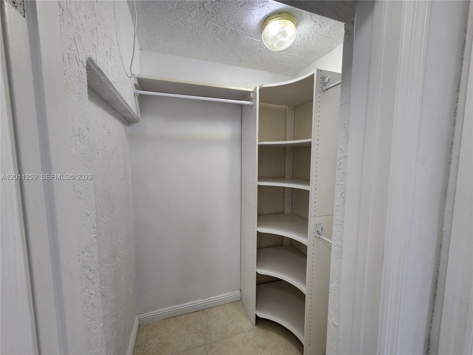 4233 Jackson Street Hollywood, FL 33021 - Photo 22 of 28 a view of walk in closet with empty racks