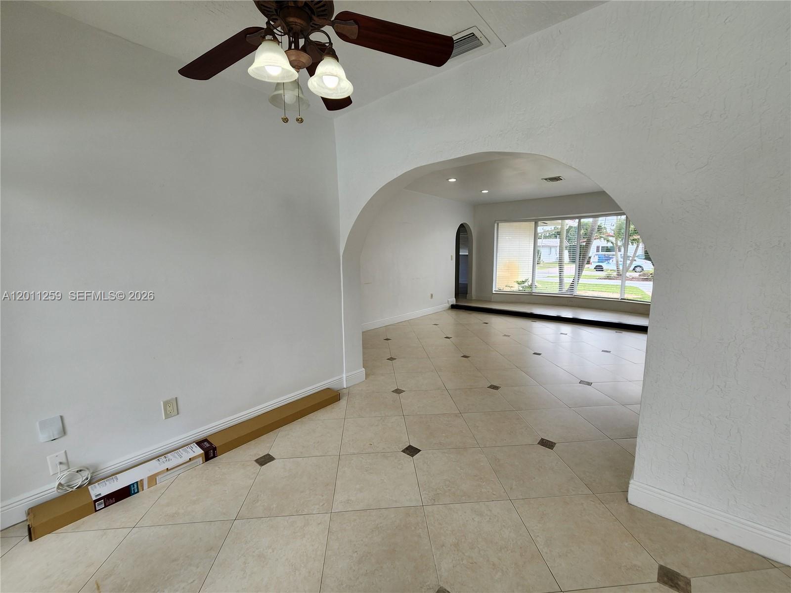 4233 Jackson Street Hollywood, FL 33021 - Photo 5 of 28 wooden floor in an empty room with a window
