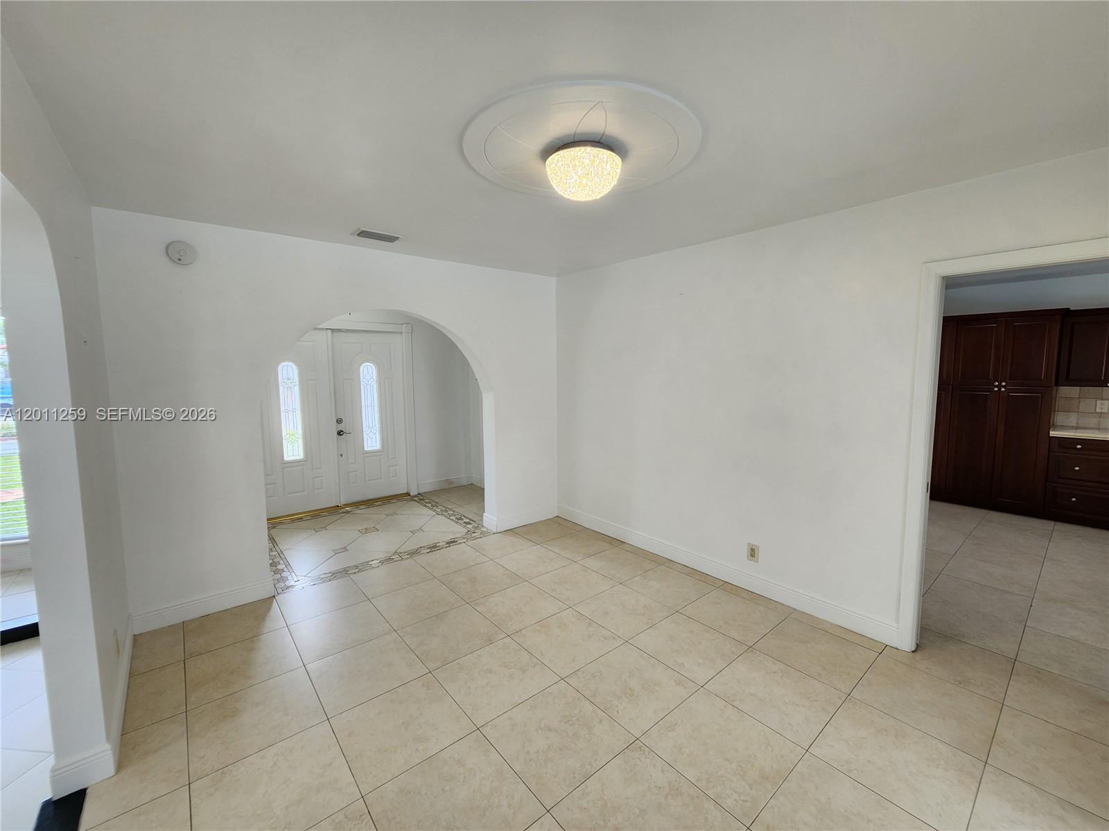 4233 Jackson Street Hollywood, FL 33021 - Photo 6 of 28 an empty room with white walls and tiles