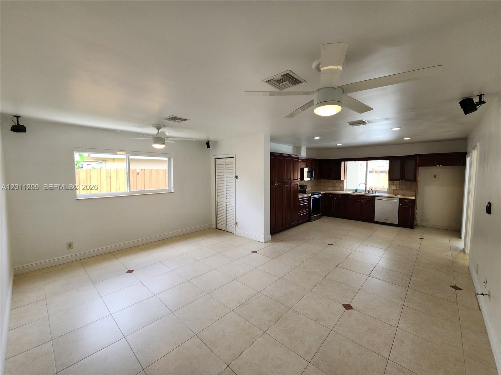 4233 Jackson Street Hollywood, FL 33021 - Photo 9 of 28 a view of empty room with kitchen and window