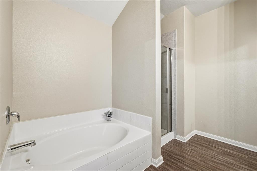 227 Curt Street Anna, TX 75409 - Photo 20 of 40 Bathroom with a stall shower, dark wood finished floors, and a bath