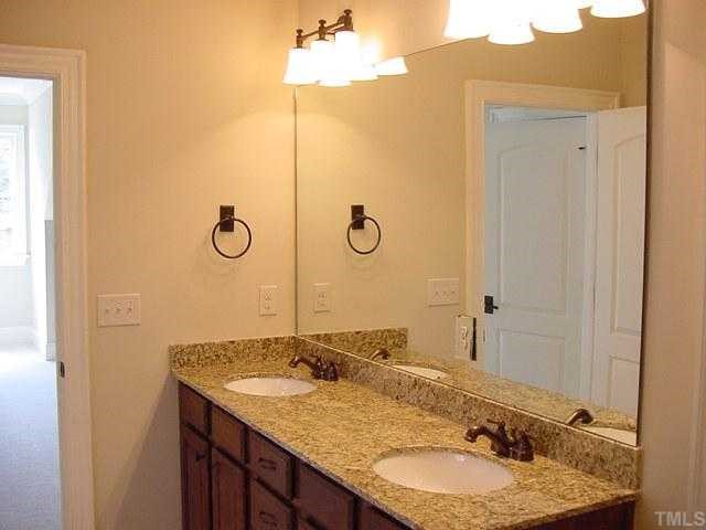 430 Lakestone Drive Raleigh, NC 27609 - Photo 11 of 12 a bathroom with a granite countertop sink and a mirror