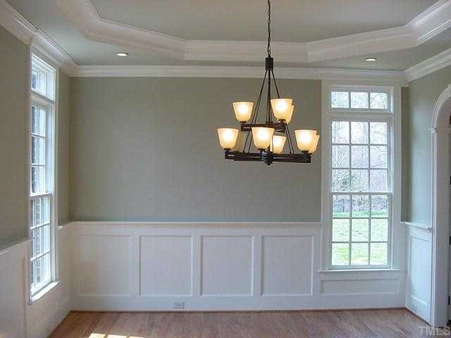 430 Lakestone Drive Raleigh, NC 27609 - Photo 2 of 12 a view of a room with wooden floor and chandelier
