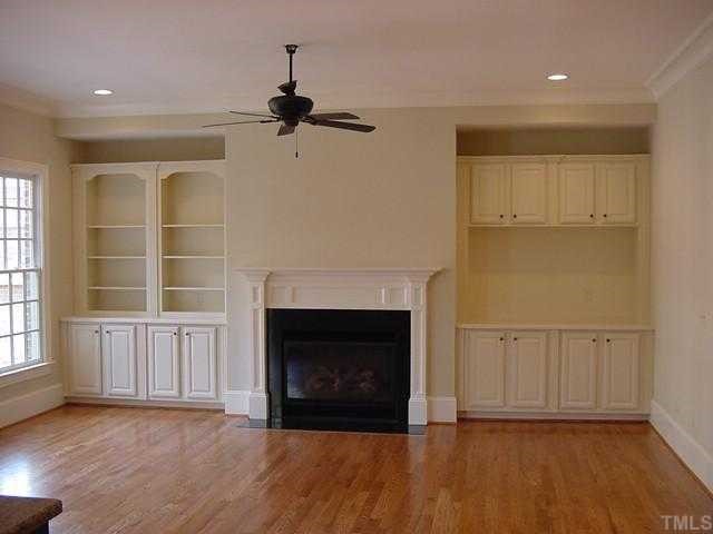430 Lakestone Drive Raleigh, NC 27609 - Photo 3 of 12 a view of a livingroom with a fireplace and window