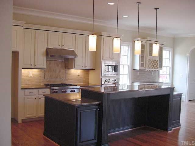 430 Lakestone Drive Raleigh, NC 27609 - Photo 4 of 12 a kitchen with stainless steel appliances granite countertop a sink a stove and a wooden floors