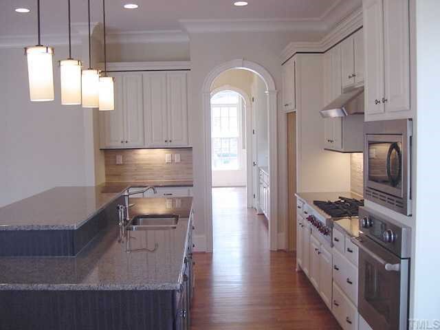 430 Lakestone Drive Raleigh, NC 27609 - Photo 5 of 12 a kitchen with stainless steel appliances granite countertop a refrigerator a stove and a sink