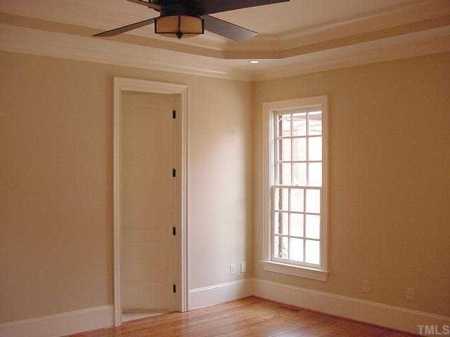 430 Lakestone Drive Raleigh, NC 27609 - Photo 6 of 12 an empty room with wooden floor closet and windows
