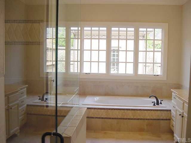 430 Lakestone Drive Raleigh, NC 27609 - Photo 7 of 12 a bathroom with a bathtub and sink