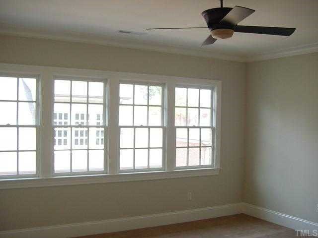 430 Lakestone Drive Raleigh, NC 27609 - Photo 8 of 12 an empty room with a empty space and windows