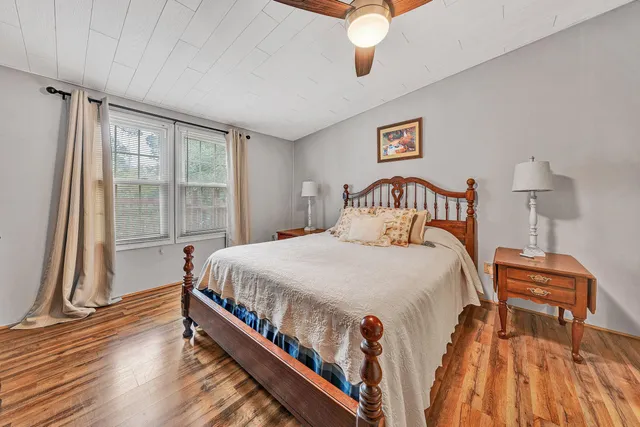 a bed sitting in a bedroom next to a window