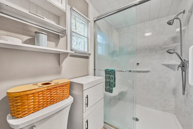 a bathroom with a shower and a sink