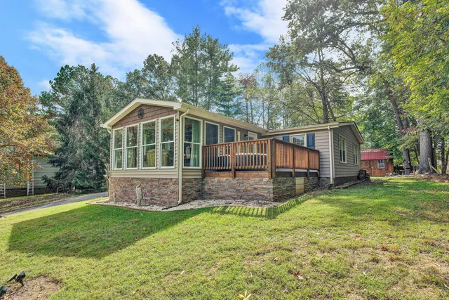 a view of a house with a yard and sitting area