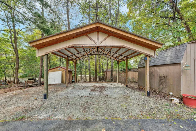 a view of a house with a yard and tree