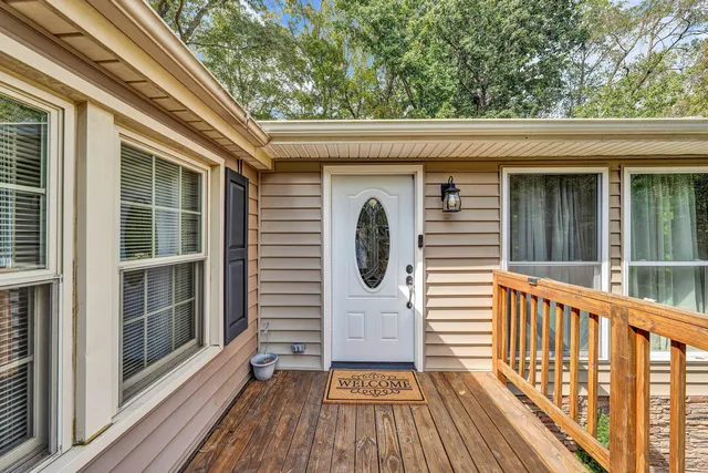 a view of a wooden deck with a yard