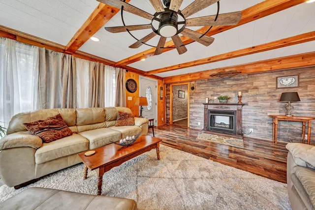 a living room with furniture a fireplace and a table