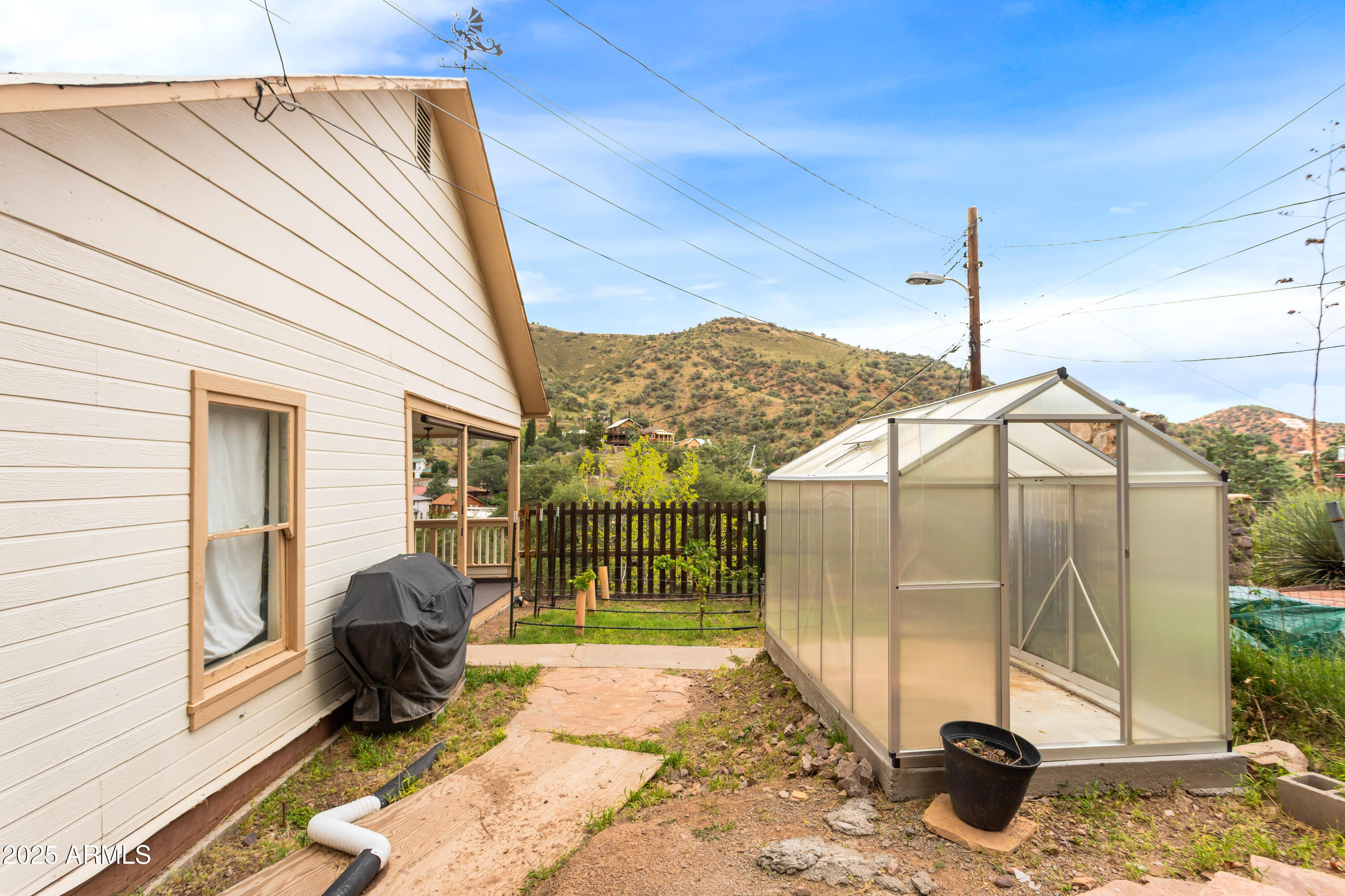 428 Brophy Avenue, Unit D Bisbee, AZ 85603 - Photo 11 of 40 a view of a two chairs in the back yard of a house