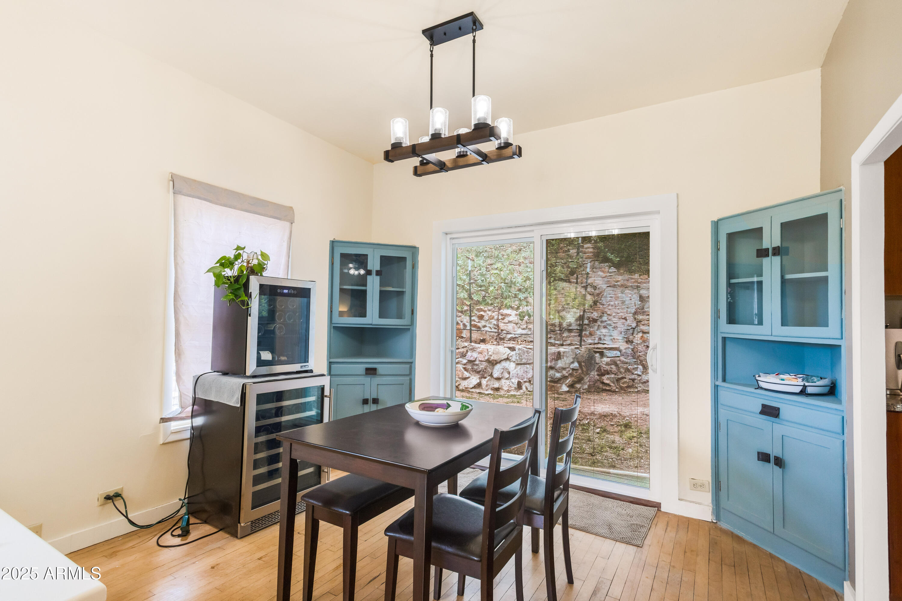 428 Brophy Avenue, Unit D Bisbee, AZ 85603 - Photo 13 of 40 a view of a dining room with furniture window and wooden floor