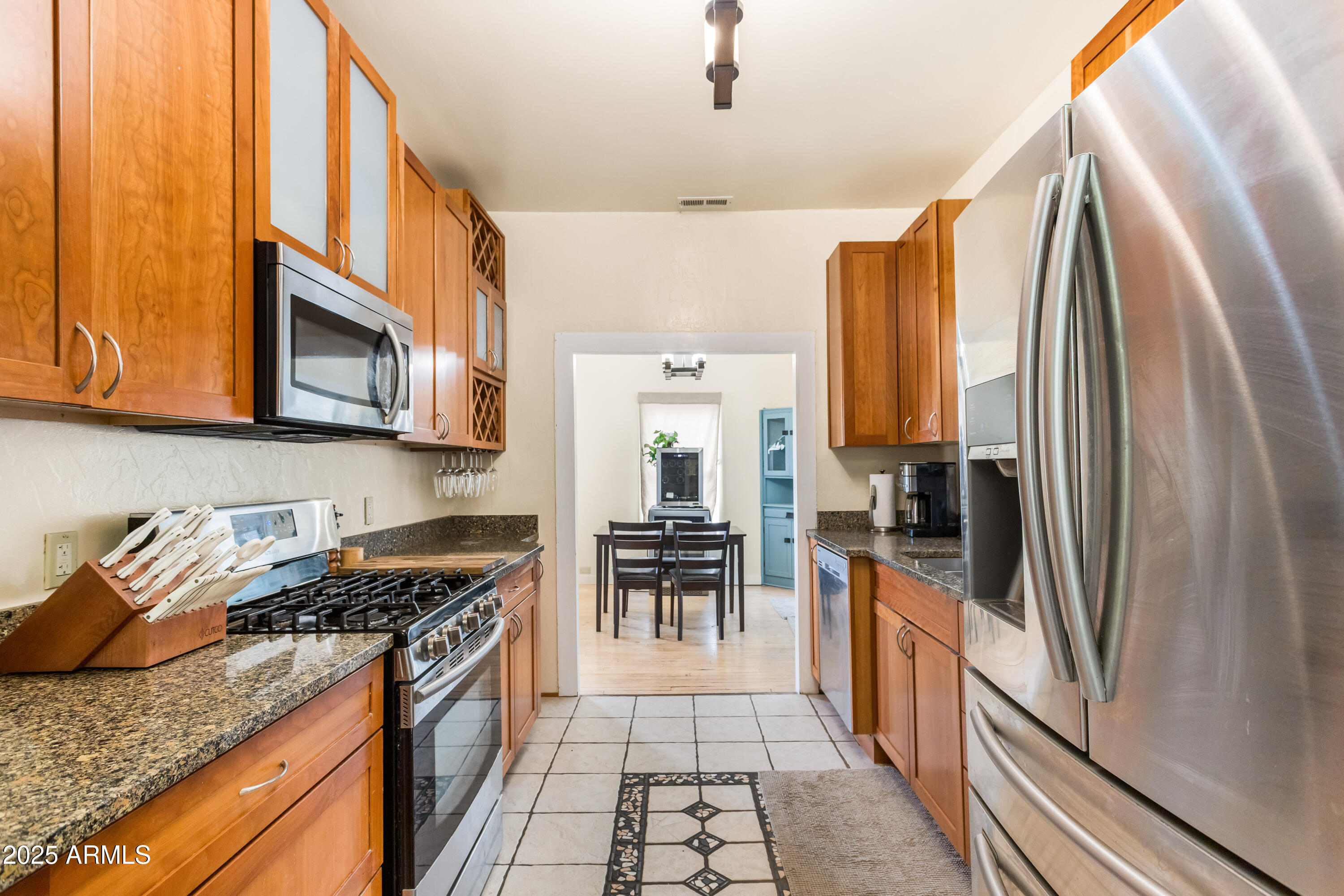 428 Brophy Avenue, Unit D Bisbee, AZ 85603 - Photo 16 of 40 a kitchen with stainless steel appliances granite countertop a refrigerator and a stove top oven
