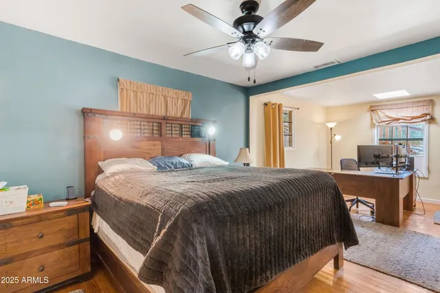 a spacious bedroom with a bed and a chandelier
