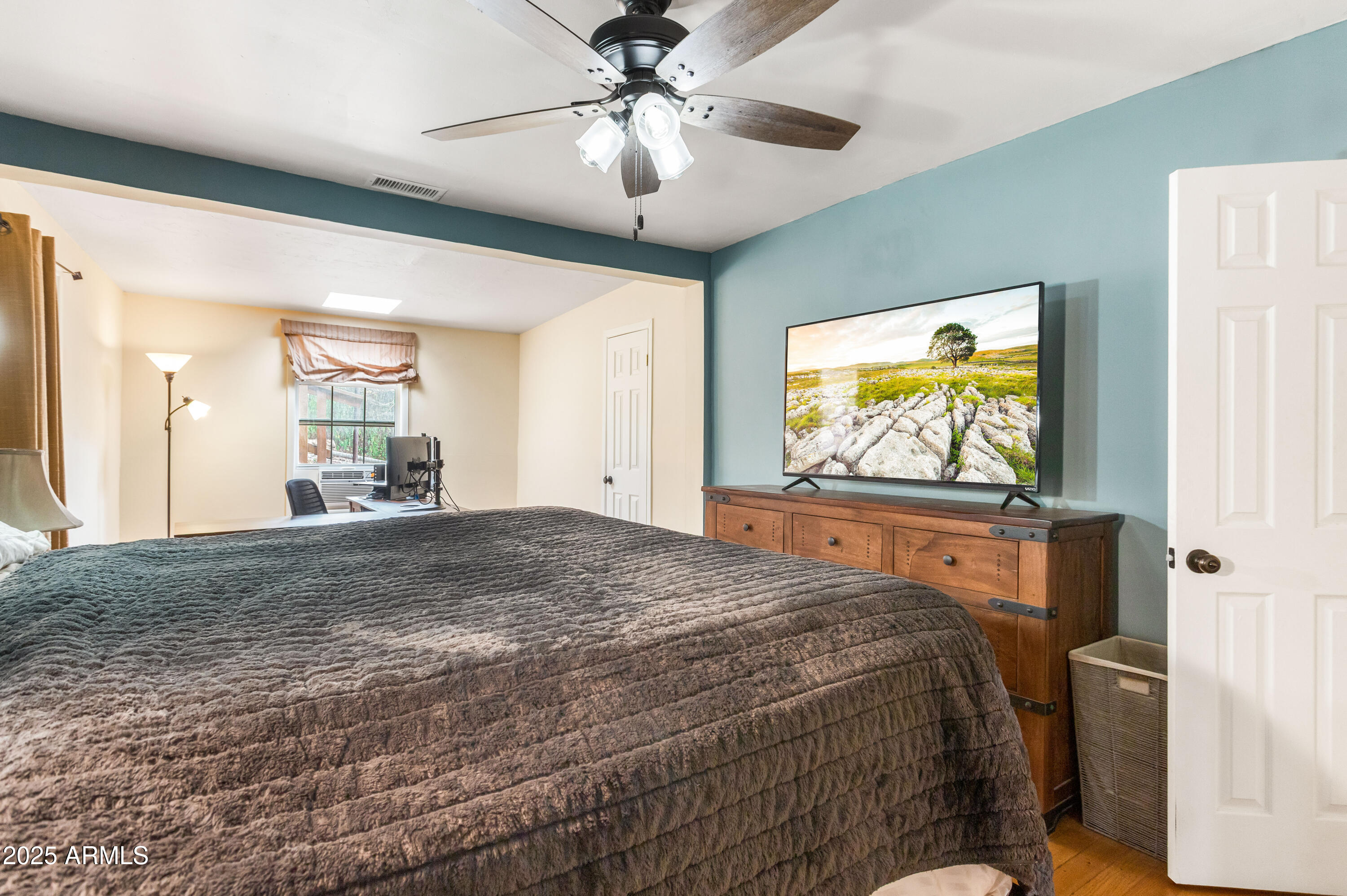 428 Brophy Avenue, Unit D Bisbee, AZ 85603 - Photo 23 of 40 a bedroom with a bed and a flat screen tv