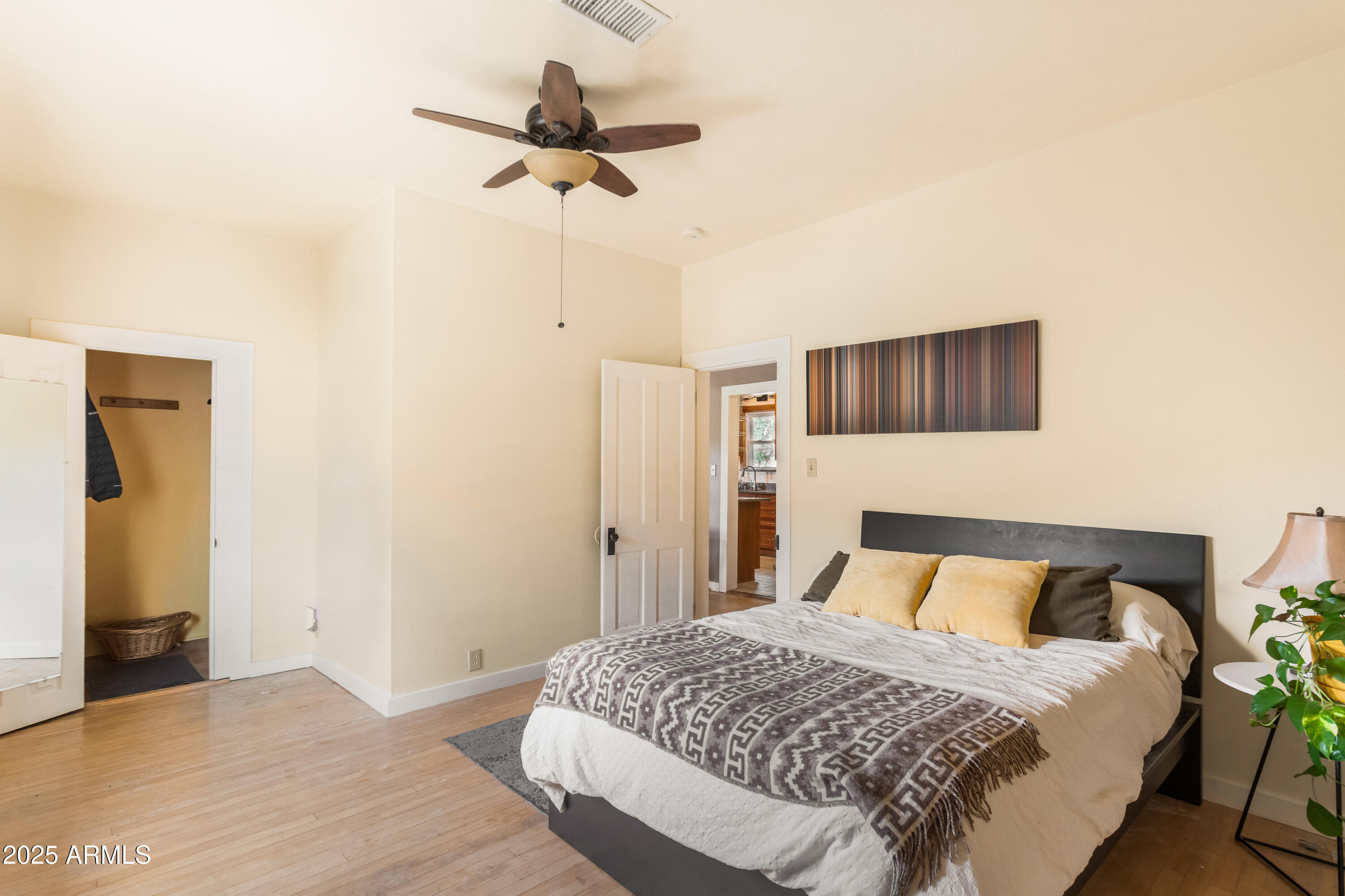 428 Brophy Avenue, Unit D Bisbee, AZ 85603 - Photo 27 of 40 a bedroom with a bed and a chandelier